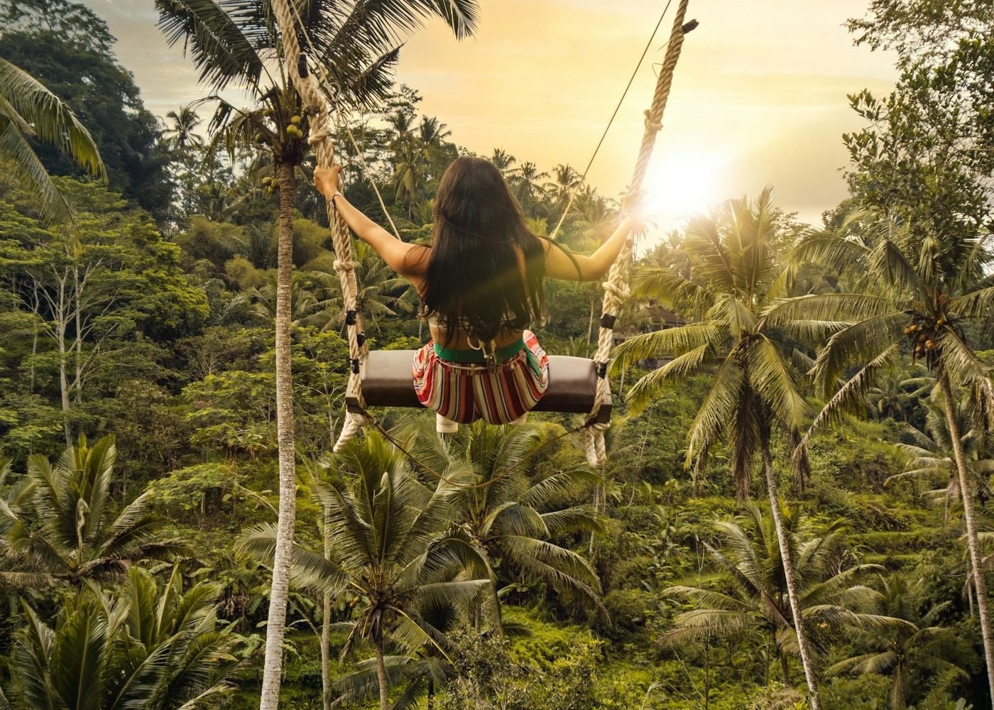 Traveller on a jungle swing above the Ubud valley
