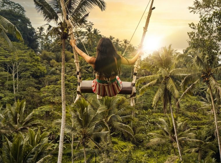 Traveller on a jungle swing above the Ubud valley