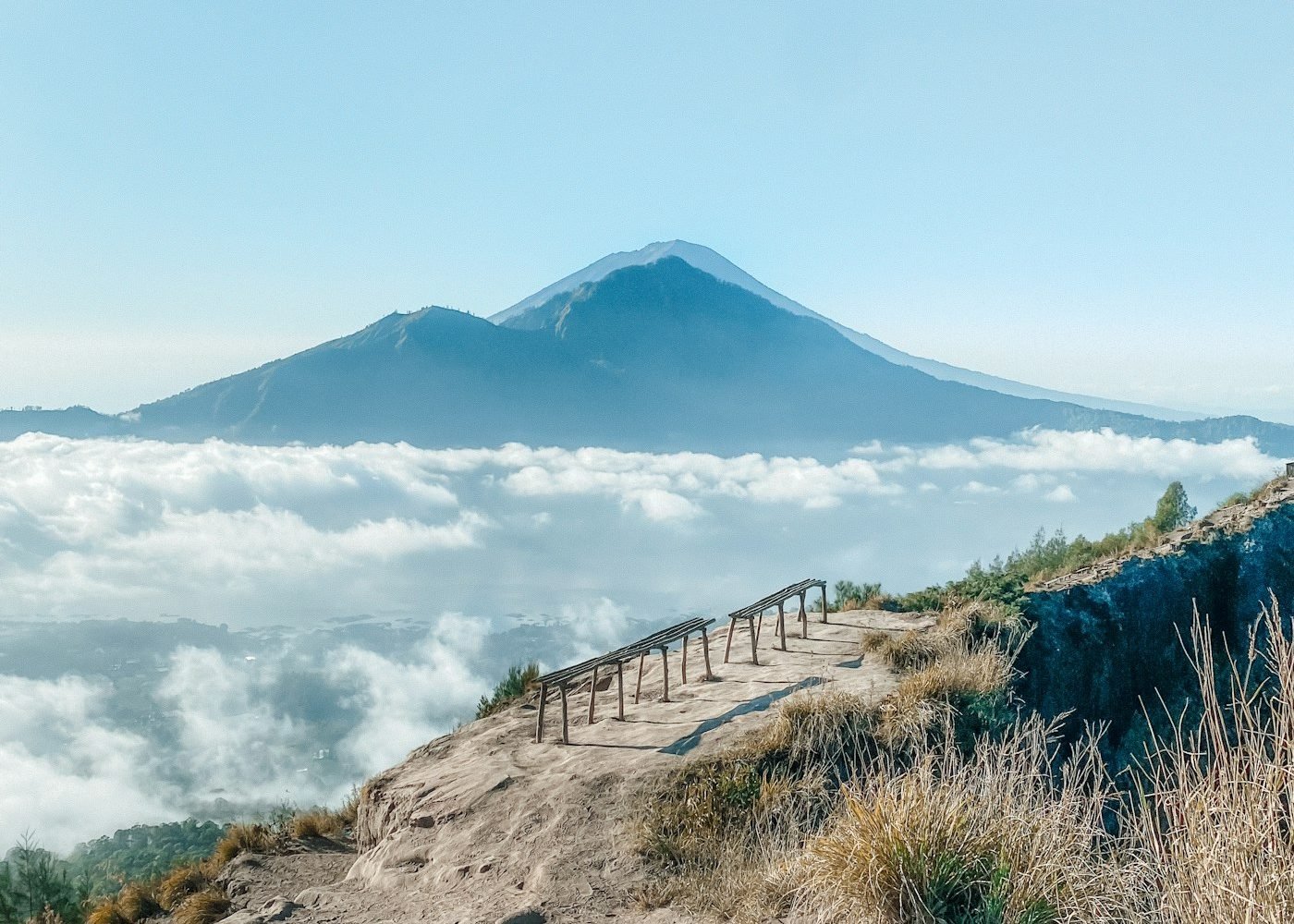 Hiker view of Mount Agung over a sea of clouds from Mount Batur