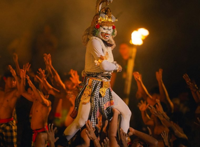 Hanuman dancer lifted by performers during the Kecak show
