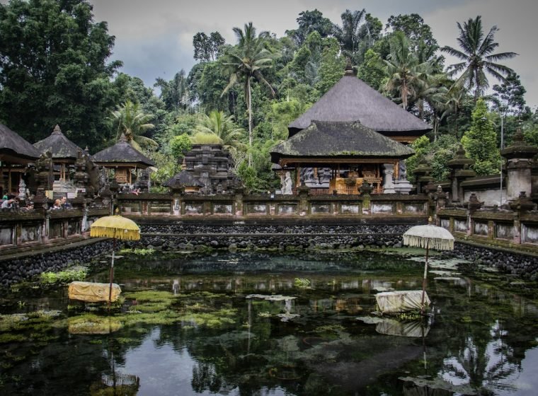 Traditional Balinese pavilions around a temple pond
