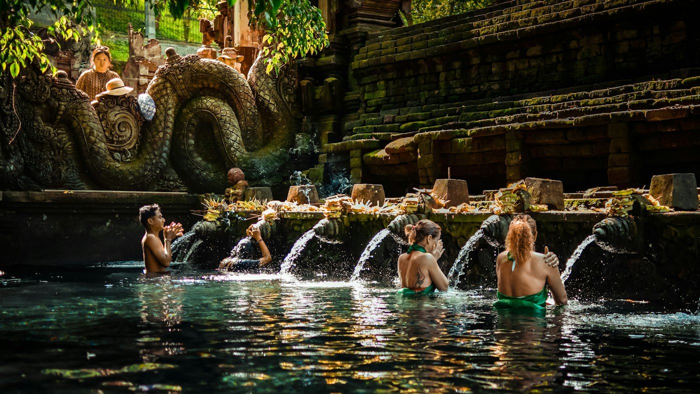 Pilgrims bathing under the spouts of Tirta Empul holy spring