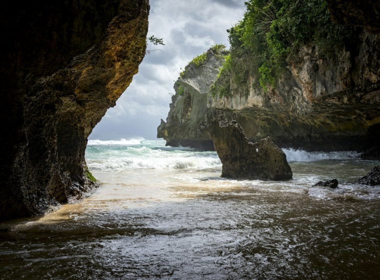 Sea cave and turquoise waves on the Uluwatu coast