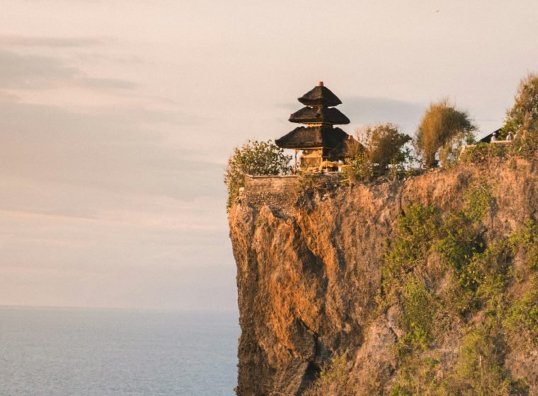 Uluwatu temple on top of a sea cliff at sunset