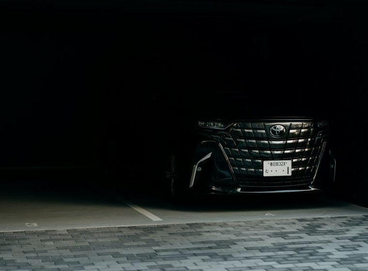 Black luxury van with headlights in a garage