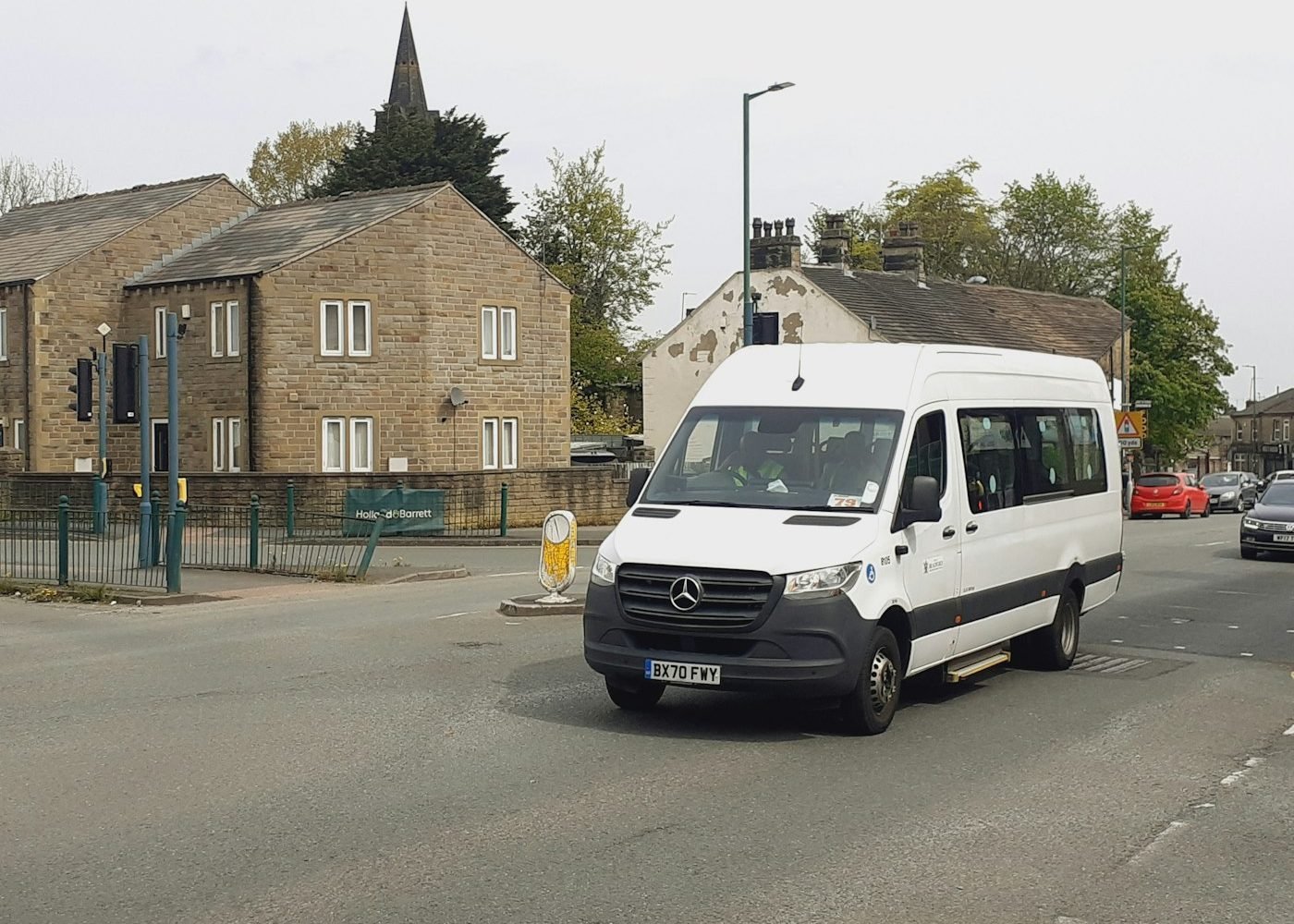 White minibus for group transfers on a city street